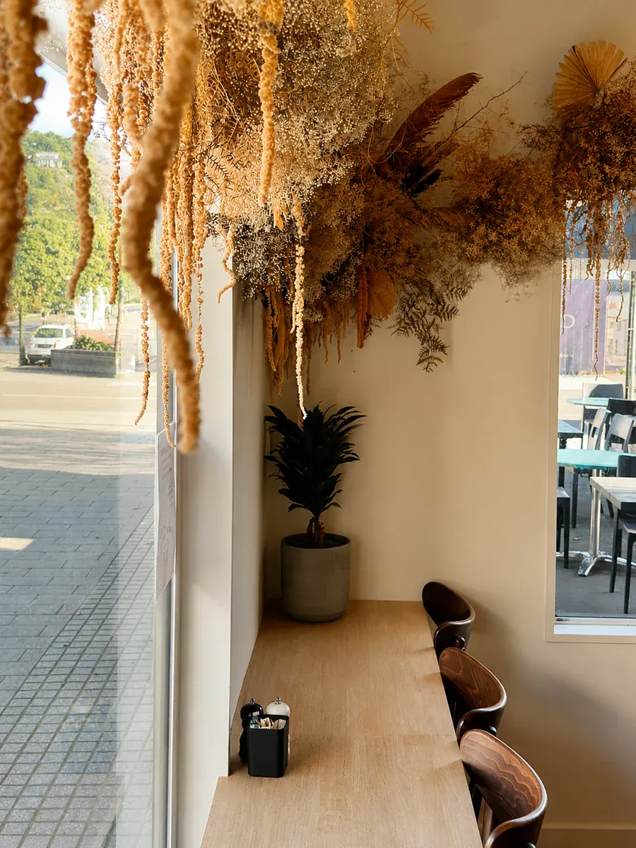 Window seating and dried floral installation inside Not typical